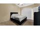 Bedroom featuring neutral walls, carpet, and a modern black platform bed at 1222 W Baseline Rd # 114, Tempe, AZ 85283