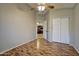Neutral bedroom with an ensuite door, laminate flooring, and a ceiling fan at 13601 S 37Th St, Phoenix, AZ 85044