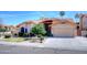 Charming single-story home with a well-manicured lawn, a two-car garage, and desert landscaping at 13601 S 37Th St, Phoenix, AZ 85044