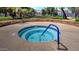 Inviting in-ground hot tub featuring a secure blue handrail and tiled interior, perfect for relaxation at 13601 S 37Th St, Phoenix, AZ 85044