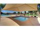 Relaxing hot tub under a shaded canopy, adjacent to a sparkling community pool, ideal for leisure at 13601 S 37Th St, Phoenix, AZ 85044