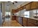 Bright kitchen area with tile flooring and wooden cabinets, adjacent to a dining area at 13601 S 37Th St, Phoenix, AZ 85044
