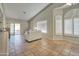 Bright and airy living room featuring neutral tones, a large window, and a sliding glass door to the backyard at 13601 S 37Th St, Phoenix, AZ 85044
