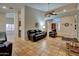 Open-concept living room with terracotta tile floors, comfortable seating, and a view of the entryway at 13601 S 37Th St, Phoenix, AZ 85044