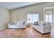 Bright living room featuring neutral decor, comfortable sofas, and natural light from the large windows at 13601 S 37Th St, Phoenix, AZ 85044