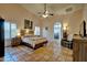 Comfortable bedroom featuring tile floors, a ceiling fan, and a large arched doorway at 13601 S 37Th St, Phoenix, AZ 85044