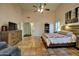 Bright main bedroom with a ceiling fan, high ceilings, and an ensuite bathroom at 13601 S 37Th St, Phoenix, AZ 85044
