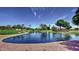 Scenic community pond featuring walking path, fountain, and mature trees at 13601 S 37Th St, Phoenix, AZ 85044