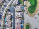 Aerial view of a residential community with lush landscaping, golf course and sparkling pools at 1414 E Amberwood Dr, Phoenix, AZ 85048