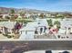 Aerial view of the community showcasing well-maintained landscaping, a community golf course and mountain views at 1414 E Amberwood Dr, Phoenix, AZ 85048