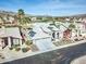 Aerial view of a home with solar panels and a lush, well-maintained desert landscaped front yard and neighborhood at 1414 E Amberwood Dr, Phoenix, AZ 85048