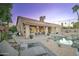 Relaxing backyard setting with lounge chairs, desert landscape, covered patio, and inviting pool with rock features at 1414 E Amberwood Dr, Phoenix, AZ 85048