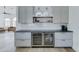 Elegant bar area with wine fridge, beverage fridge, light gray cabinets, and subway tile backsplash at 1414 E Amberwood Dr, Phoenix, AZ 85048