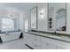Bright bathroom featuring double vanity, modern soaking tub, and decorative lighting at 1414 E Amberwood Dr, Phoenix, AZ 85048