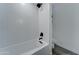 Bright bathroom featuring a tub with a tiled shower and sleek black fixtures at 1414 E Amberwood Dr, Phoenix, AZ 85048