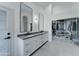 Bathroom featuring double vanity, modern lighting, and a custom-built walk-in closet at 1414 E Amberwood Dr, Phoenix, AZ 85048