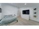 Bright bedroom featuring wood floors, a television, and a ceiling fan at 1414 E Amberwood Dr, Phoenix, AZ 85048