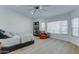 Bright bedroom features a ceiling fan, hardwood floors and natural light at 1414 E Amberwood Dr, Phoenix, AZ 85048