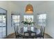 Bright breakfast nook features a round wooden table, seating for four, and multiple windows at 1414 E Amberwood Dr, Phoenix, AZ 85048