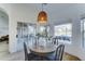 Bright breakfast nook features a round wooden table with seating for four, and sliding glass doors to patio at 1414 E Amberwood Dr, Phoenix, AZ 85048