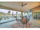 Relaxing covered patio features comfortable seating, ceiling fan and view of the pool and desert landscaped backyard at 1414 E Amberwood Dr, Phoenix, AZ 85048