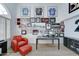 Spacious home office featuring a red leather armchair and wall decor at 1414 E Amberwood Dr, Phoenix, AZ 85048