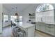Open kitchen with island seating, stainless steel appliances and ample natural light at 1414 E Amberwood Dr, Phoenix, AZ 85048
