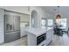 Bright kitchen featuring stainless steel appliances, large center island with seating and white cabinets at 1414 E Amberwood Dr, Phoenix, AZ 85048
