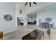Spacious living area boasting an open layout, light wood floors, neutral walls, and stylish decor at 1414 E Amberwood Dr, Phoenix, AZ 85048