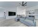 Bright living room with modern gray sofa, vaulted ceilings, and bar area perfect for entertaining at 1414 E Amberwood Dr, Phoenix, AZ 85048