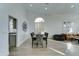 Dining and living area featuring wood-look floors, modern decor, and an open layout at 1414 E Amberwood Dr, Phoenix, AZ 85048