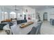 Expansive living room featuring wood-look floors, modern lighting, and a dining space at 1414 E Amberwood Dr, Phoenix, AZ 85048