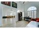 Bright living room featuring a piano, leather sofa, and hardwood floors at 1414 E Amberwood Dr, Phoenix, AZ 85048