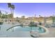 Backyard pool with desert landscaping including stones, cacti, and palm trees at 1414 E Amberwood Dr, Phoenix, AZ 85048