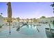 Backyard pool with desert landscaping, rock waterfall, and lounge chairs at 1414 E Amberwood Dr, Phoenix, AZ 85048