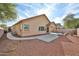 The home has a large backyard with a stone landscape and sidewalk leading to the driveway at 14720 W Edgemont Ave, Goodyear, AZ 85395
