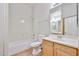 Bathroom with a tub and shower combination and a wooden vanity with a mirror at 14720 W Edgemont Ave, Goodyear, AZ 85395