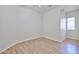 Bedroom featuring sleek wood floors and a fan for added comfort at 14720 W Edgemont Ave, Goodyear, AZ 85395