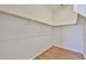 Walk-in closet with white walls, shelves, and wooden rod for hanging clothes at 14720 W Edgemont Ave, Goodyear, AZ 85395