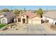 Charming single-story home featuring a well-maintained front yard and a two-car garage at 14720 W Edgemont Ave, Goodyear, AZ 85395