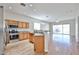 Open-concept kitchen featuring stainless steel appliances and light wood cabinetry at 14720 W Edgemont Ave, Goodyear, AZ 85395