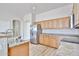 Well-lit kitchen boasting a stainless steel refrigerator, light wood cabinets, and laminate countertops at 14720 W Edgemont Ave, Goodyear, AZ 85395