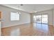 Spacious living area with wood-look flooring, a modern chandelier, and sliding door to patio at 14720 W Edgemont Ave, Goodyear, AZ 85395