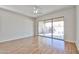 Bright living room with wood floors and sliding glass doors to the outside patio at 14720 W Edgemont Ave, Goodyear, AZ 85395