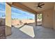 Covered patio features a ceiling fan and an open view of the backyard space at 14720 W Edgemont Ave, Goodyear, AZ 85395