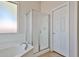 Bright white shower with a glass door and tiled floor at 14720 W Edgemont Ave, Goodyear, AZ 85395