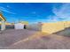 Backyard featuring a gravel area, a storage shed, and a block wall at 1625 S 113Th Ave, Avondale, AZ 85323