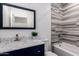 Bathroom features a tiled shower, bathtub, vanity with marble countertop, and mirror at 1625 S 113Th Ave, Avondale, AZ 85323