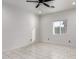 Bedroom with marble-look tile, a ceiling fan, and a bright window at 1625 S 113Th Ave, Avondale, AZ 85323