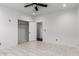 A bright bedroom featuring neutral walls, marble-look tile flooring, and two closets at 1625 S 113Th Ave, Avondale, AZ 85323